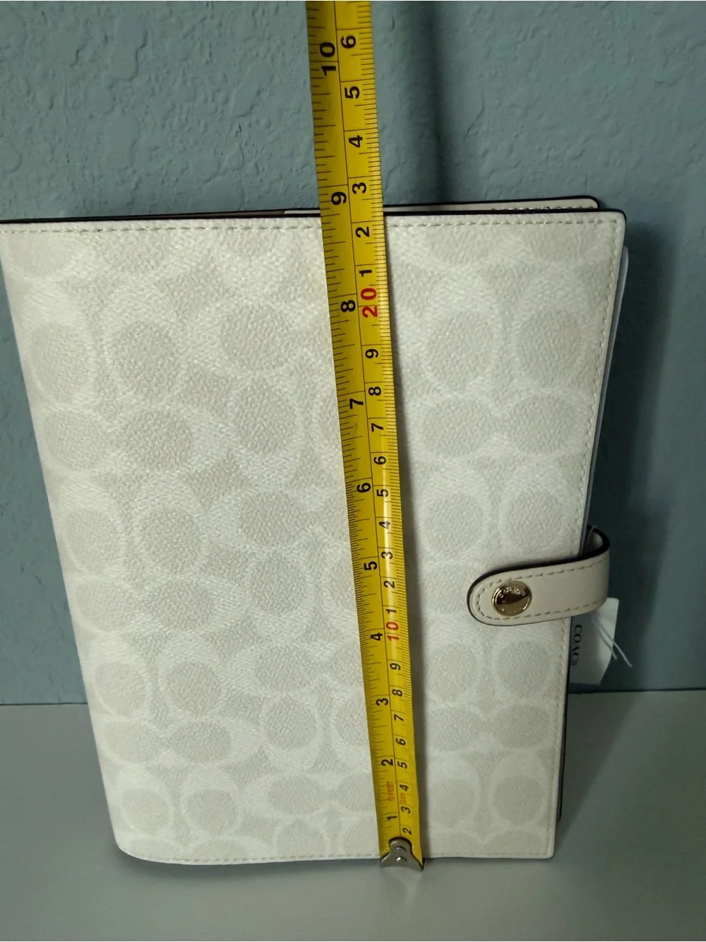 Brand new white coach notebook.